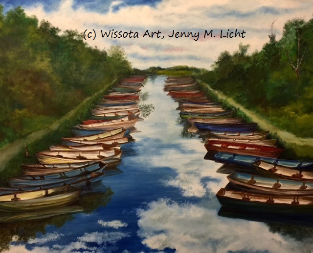 A line of classic Irish fishing boats moored bow to stern in bright reds, greens and blues.