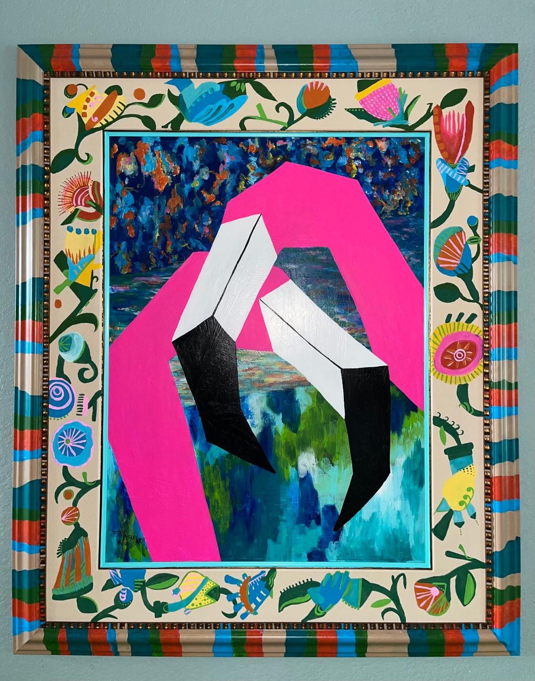 Geometric flamingos against abstract watery and forested shapes, in a painted wood frame whose mat is painted with loose flowers.